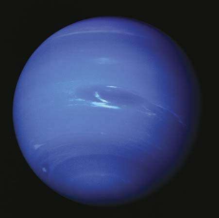 Clouds appear in Neptune's dynamic atmosphere in an image captured by Voyager 2 in 1989. At the centre is the Great Dark Spot, a swirling storm system the size of Earth, and its associated methane-ice clouds. The giant storm system had disappeared by 1991.